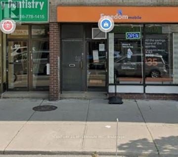 Toronto (Blake-Jones) apartment for rent - A building with a sign that says Freedom Mobile.