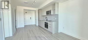 Toronto (Dovercourt-Wallace Emerson-Junction) condo for rent - A spacious kitchen with white cabinets and a microwave above the stove.