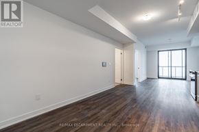 Burlington (Brant) condo for rent - A spacious room with wooden floors and white walls.
