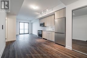 Burlington (Brant) condo for rent - A spacious kitchen with stainless steel appliances and wooden flooring.