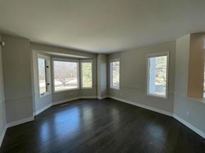 Winnipeg apartment for rent - A room with wooden floors and three windows.