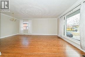 Toronto (Wexford-Maryvale) apartment for rent - A room with wooden floors and white walls, a chandelier, and a window with white curtains.