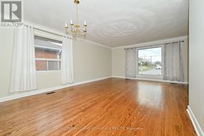 Toronto (Wexford-Maryvale) apartment for rent - A room with wooden floors and a chandelier.