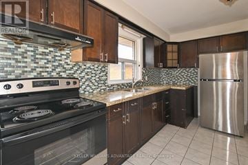 Toronto (Wexford-Maryvale) apartment for rent - A kitchen with a black stove top oven and a black refrigerator.