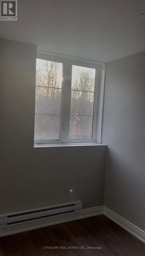 Pickering apartment for rent - A room with a window and a wall with a logo that says REALTOR.