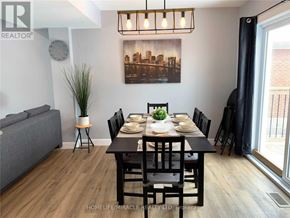 Niagara Falls (Hospital) apartment for rent - A dining room with a wooden table set for six.
