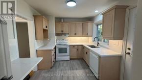 Toronto (Banbury-Don Mills) apartment for rent - A kitchen with white appliances and wooden cabinets.
