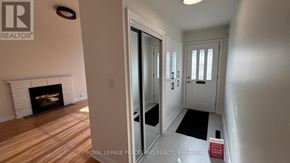 Toronto (Banbury-Don Mills) apartment for rent - A room with a fireplace and a door leading to another room.