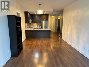 Burnaby apartment for rent - A spacious kitchen with dark wood floors and modern appliances.