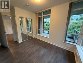 Burnaby apartment for rent - A room with a sliding glass door and wooden flooring.