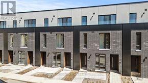 St. Catharines (Oakdale) townhouse for rent - A modern building with a grey facade and black accents.