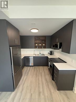 St. Catharines (Oakdale) townhouse for rent - A modern kitchen with dark wood cabinets and stainless steel appliances.