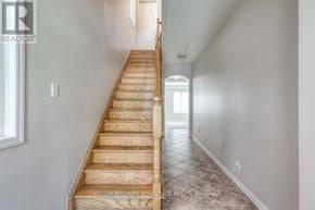 Toronto (Clairlea-Birchmount) apartment for rent - A long flight of wooden stairs leads to a doorway.