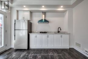 Toronto (Clairlea-Birchmount) apartment for rent - A modern kitchen with a stainless steel refrigerator and white cabinets.