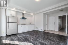 Toronto (Clairlea-Birchmount) apartment for rent - A kitchen with white cabinets and a stainless steel refrigerator.