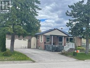 Richmond Hill (Crosby) apartment for rent - A house with a driveway and a bicycle parked on the side.