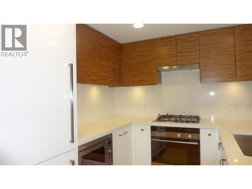 Richmond apartment for rent - A modern kitchen with wooden cabinets and stainless steel appliances.
