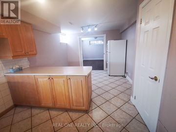 Mississauga (Erindale) apartment for rent - A kitchen with wooden cabinets and a white refrigerator.