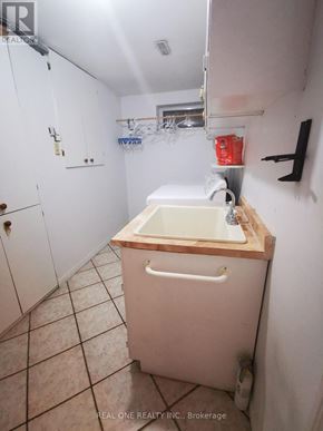Mississauga (Erindale) apartment for rent - A white bathroom with a wooden counter top and a white sink.
