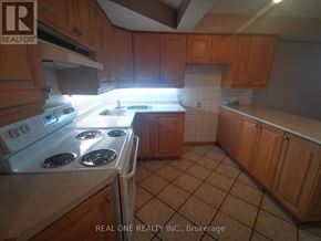 Mississauga (Erindale) apartment for rent - A kitchen with a white stove top oven and wooden cabinets.