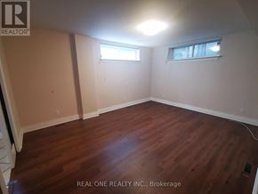 Mississauga (Erindale) apartment for rent - A room with wooden flooring and two windows.