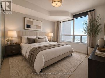 Toronto (Bendale) condo for rent - A well-lit bedroom with a large bed and a view of the city.
