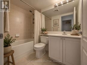 Toronto (Bendale) condo for rent - A white bathroom with a toilet, sink, and bathtub.