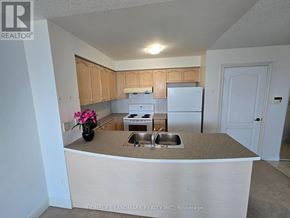 Toronto (Bendale) condo for rent - A kitchen with a sink, stove, and refrigerator.