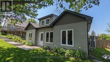 Barrie (Codrington) apartment for rent - A house with a well-maintained lawn and garden in front.