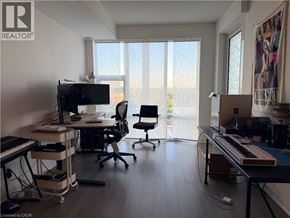 Kitchener condo for rent - A room with a desk, chairs, and a keyboard.