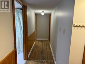 Kawartha Lakes (Lindsay) apartment for rent - A hallway with wood floors and white walls.