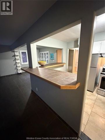 Windsor apartment for rent - A kitchen with a counter top and a staircase in the background.