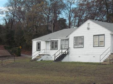 Birmingham apartment for rent - A white house with a grey roof and a black staircase.