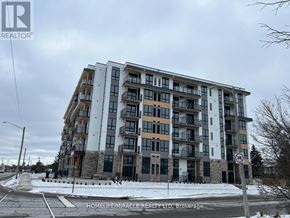 Waterloo condo for rent - A large apartment building with a sign that says "REALTOR" on the top left corner.