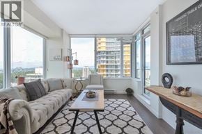Burnaby apartment for rent - A living room with a large window and a view of a city skyline.