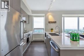 Burnaby apartment for rent - A modern kitchen with stainless steel appliances and a view of the city.