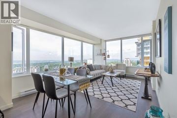 Burnaby apartment for rent - A modern living room with a glass table and chairs.