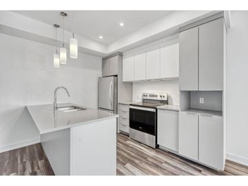 Gatineau (Aylmer) apartment for rent - A modern kitchen with white cabinets and stainless steel appliances.
