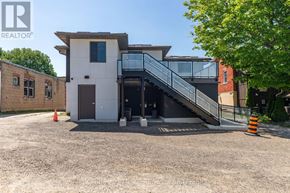 Arran-Elderslie apartment for rent - A modern house with a white exterior and a glass staircase leading to the entrance.