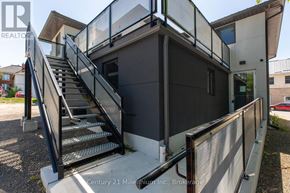 Arran-Elderslie apartment for rent - A staircase with a metal railing leads up to a building entrance.
