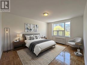 Toronto (Rosedale-Moore Park) condo for rent - A bedroom with a large bed and a chair.