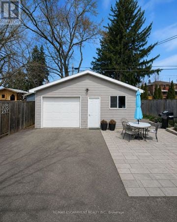 Brantford apartment for rent - A garage with a table and chairs outside.