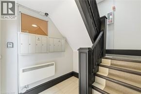 Hamilton apartment for rent - A staircase with a black railing and beige steps.