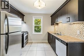 Hamilton apartment for rent - A kitchen with a refrigerator, oven, and sink.
