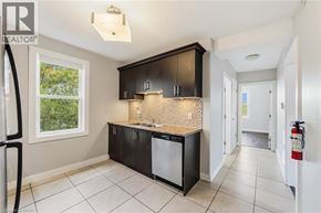 Hamilton apartment for rent - A kitchen with black cabinets and a white dishwasher.