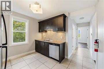 Hamilton apartment for rent - A kitchen with black cabinets and a white dishwasher.