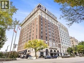 Hamilton condo for rent - A tall building with a sign that says "REALTOR" on the top left corner.