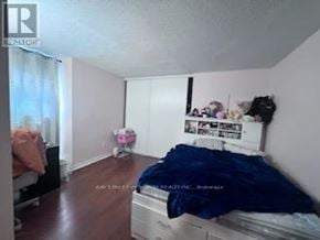 Toronto (Hillcrest Village) townhouse for rent - A bedroom with a bed, dresser, and window.