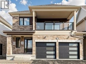 Clarington (Courtice) apartment for rent - A modern two-story house with a balcony on the upper floor.