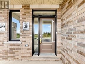 Clarington (Courtice) apartment for rent - A brown door with a glass window above it and a sign that says 36 on it.
